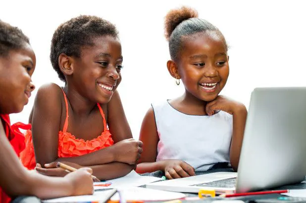 Child solving coding challenges or building a simple game.